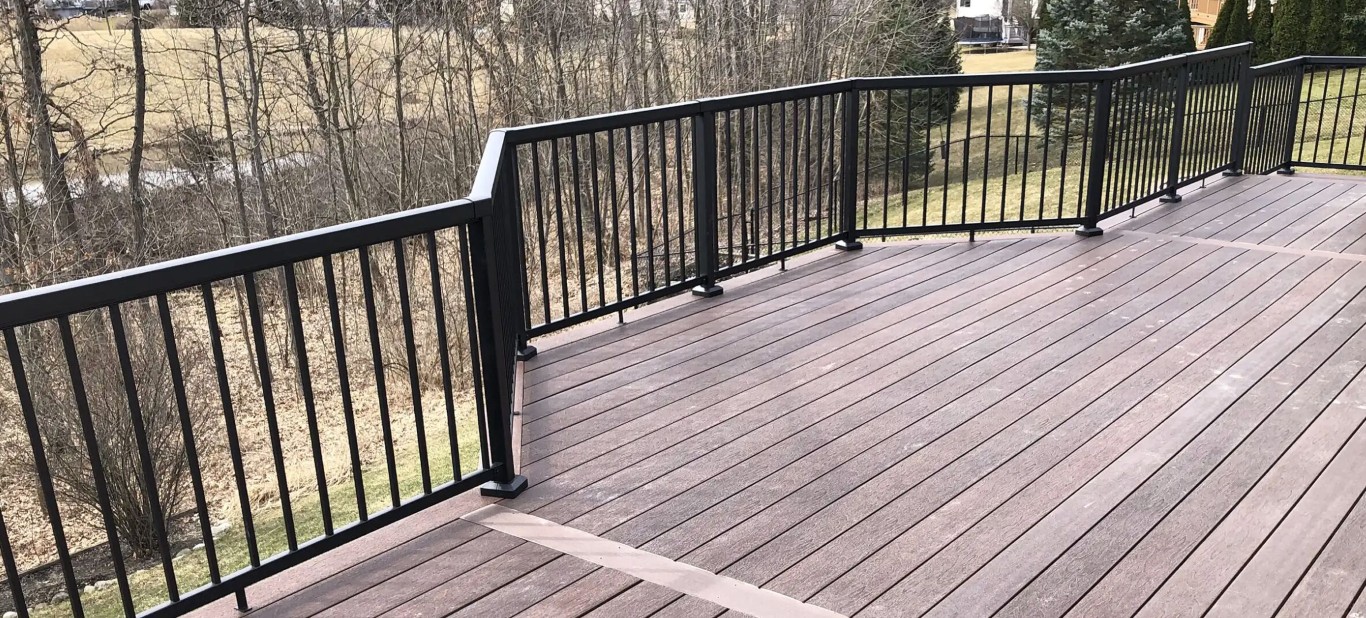 Composite deck with black metal railings installed in Tulare residential property
