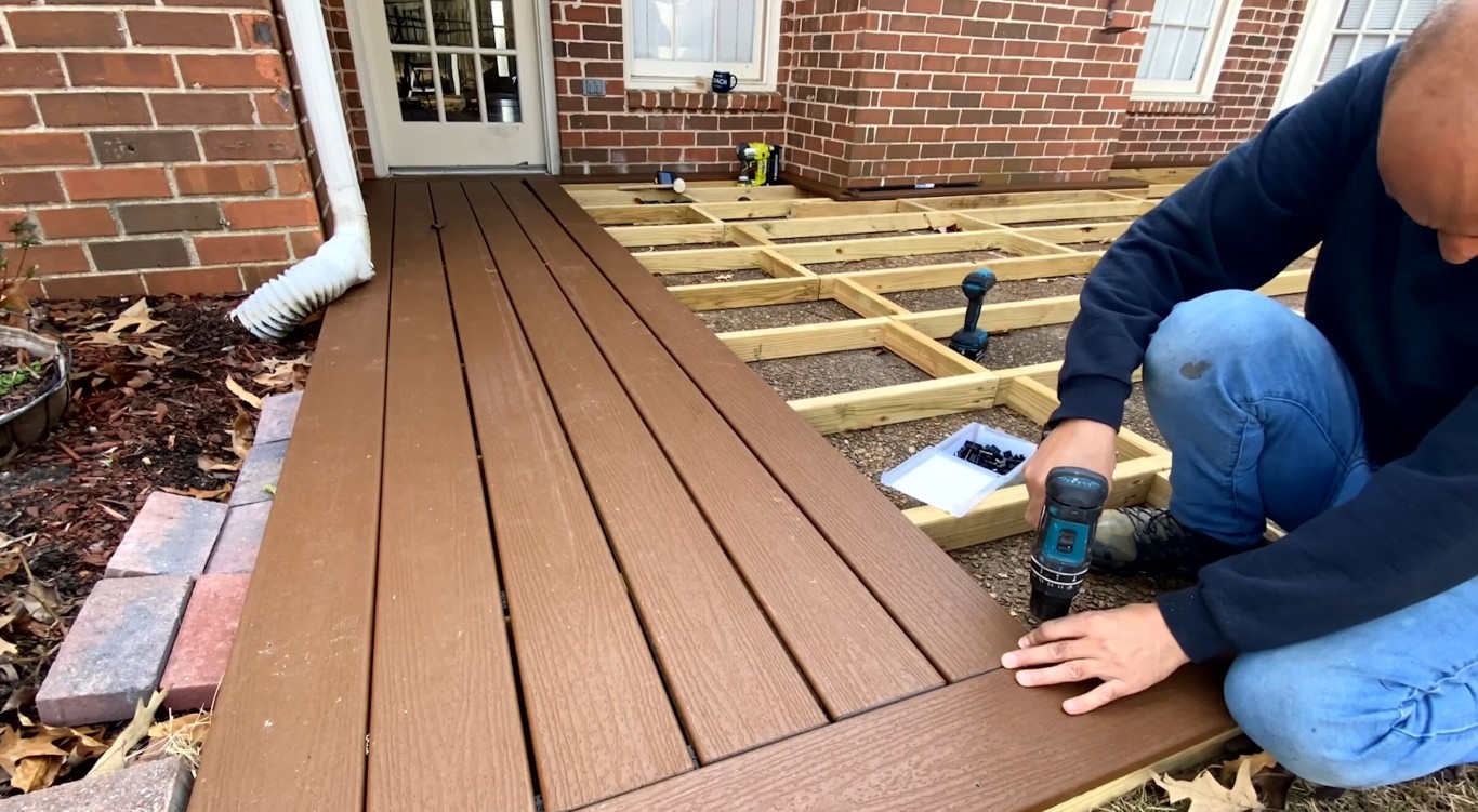 Professional crew installing composite deck in Tulare residential backyard