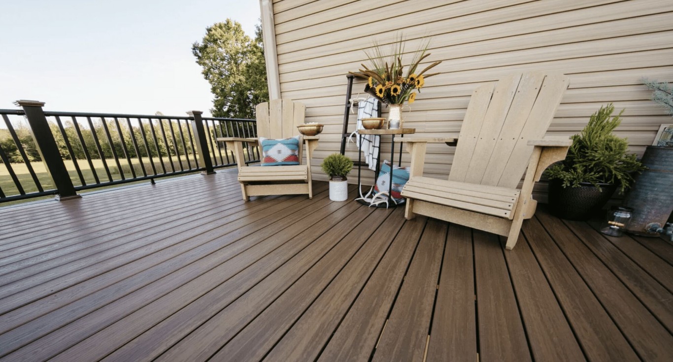 Relaxing deck with comfortable outdoor furniture and decorative plants in Tulare home
