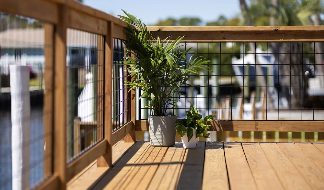 Quality wood deck with wire mesh railing detail in Tulare backyard